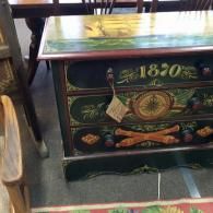 A vintage dark green, hand-painted wooden chest of drawers featuring the year 1870 and nautical-themed artwork.