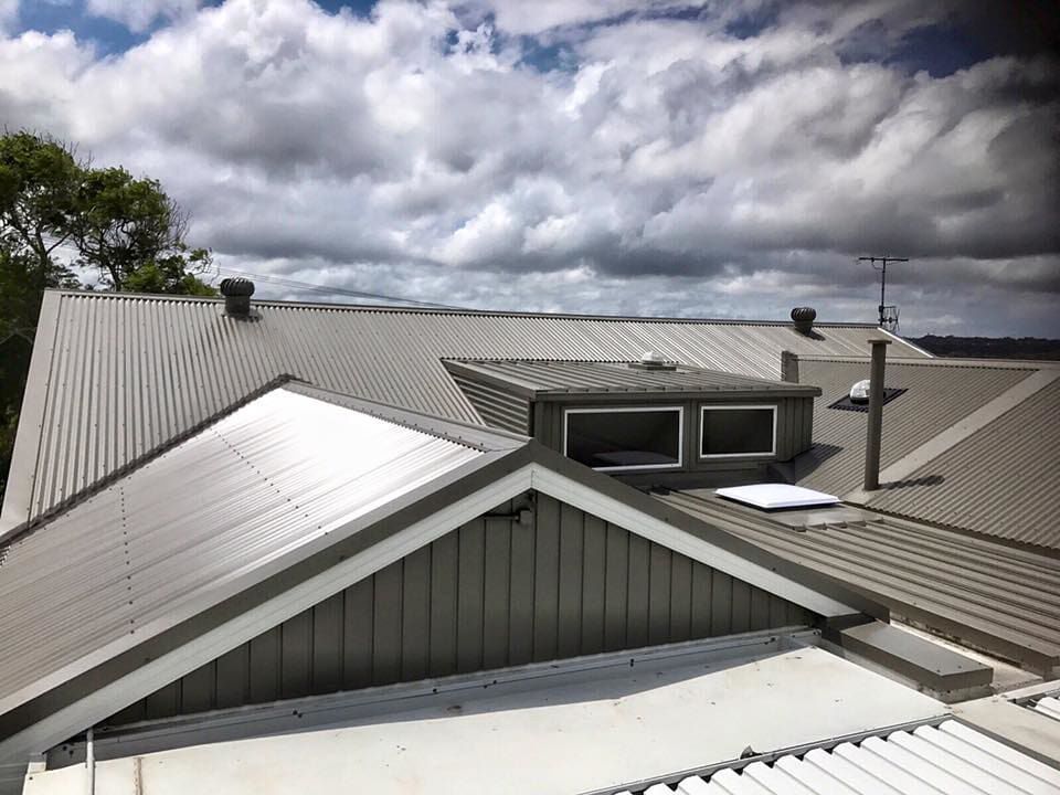 A House Roof with Clouds in the Background — Roofing in Newcastle, NSW