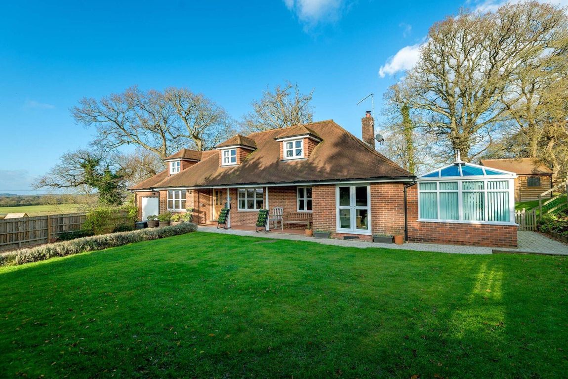 A shot of a New Forest Chalet with conservatory and double garage. t