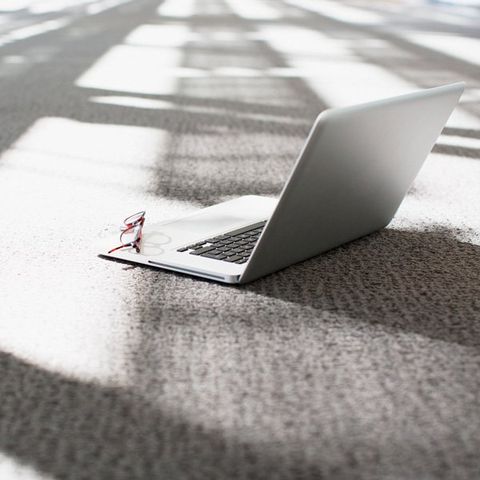 laptop and glasses on carpet