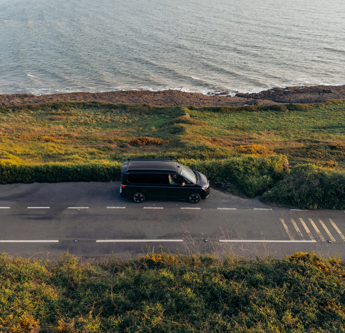 California Ocean campervan driving down a road