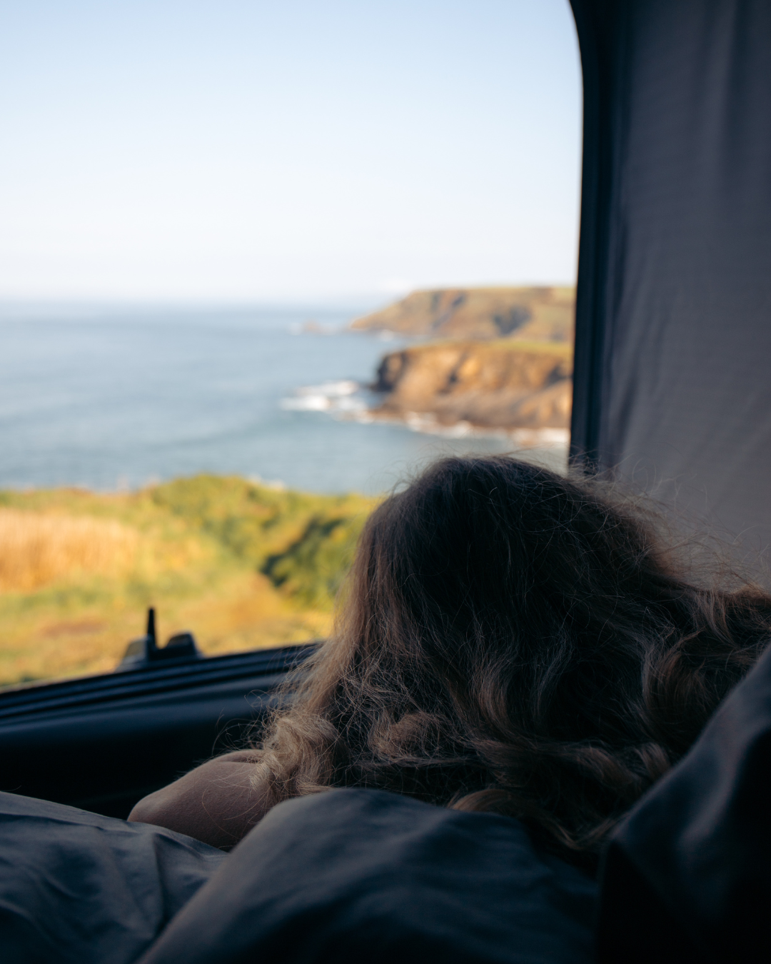Sleeping in the pop top of the New California ocean available for rental