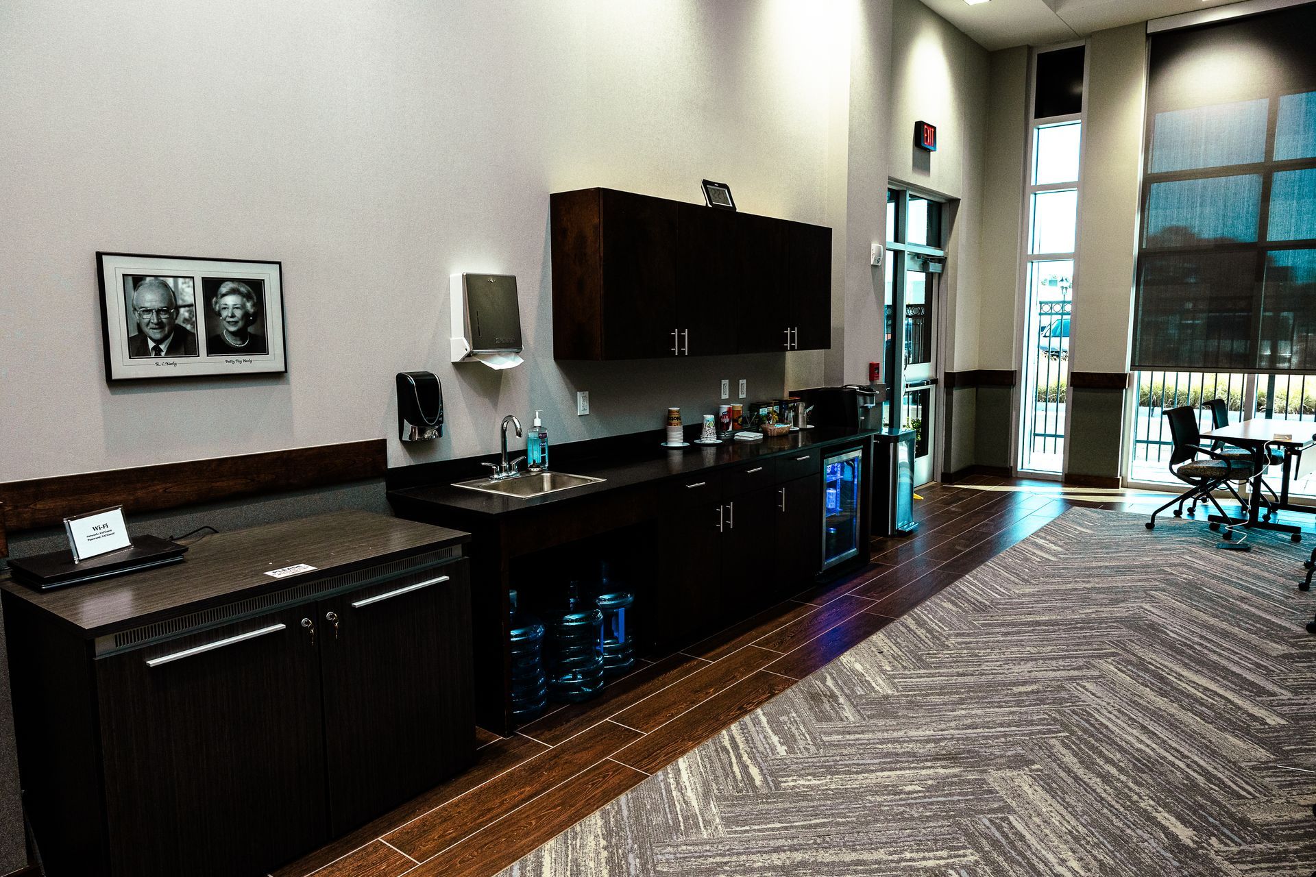 A kitchen with a picture of two men on the wall