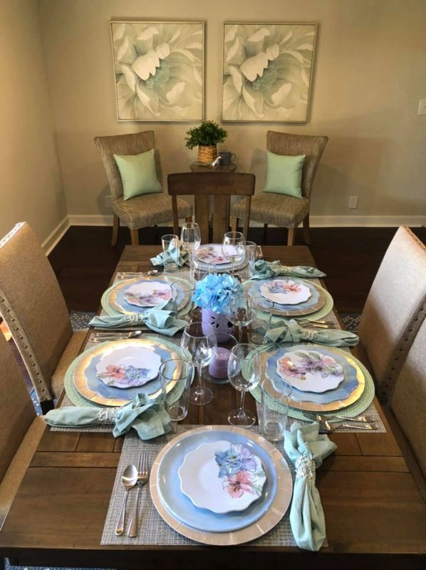 tableware and silver ware neatly aligned on dining table