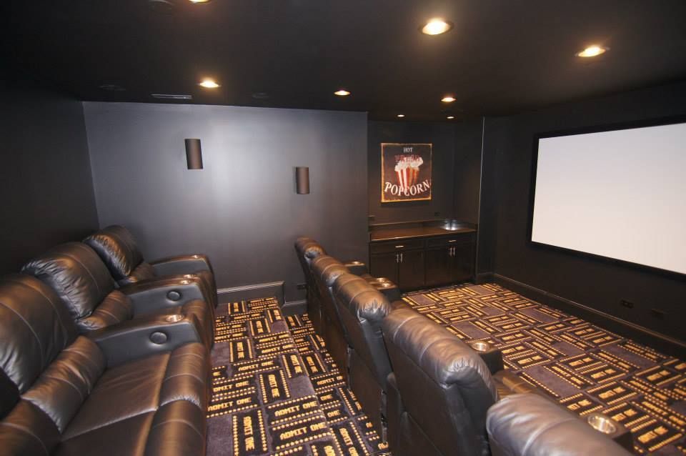 Two people looking at a blueprint on a table in a modern office, one pointing.