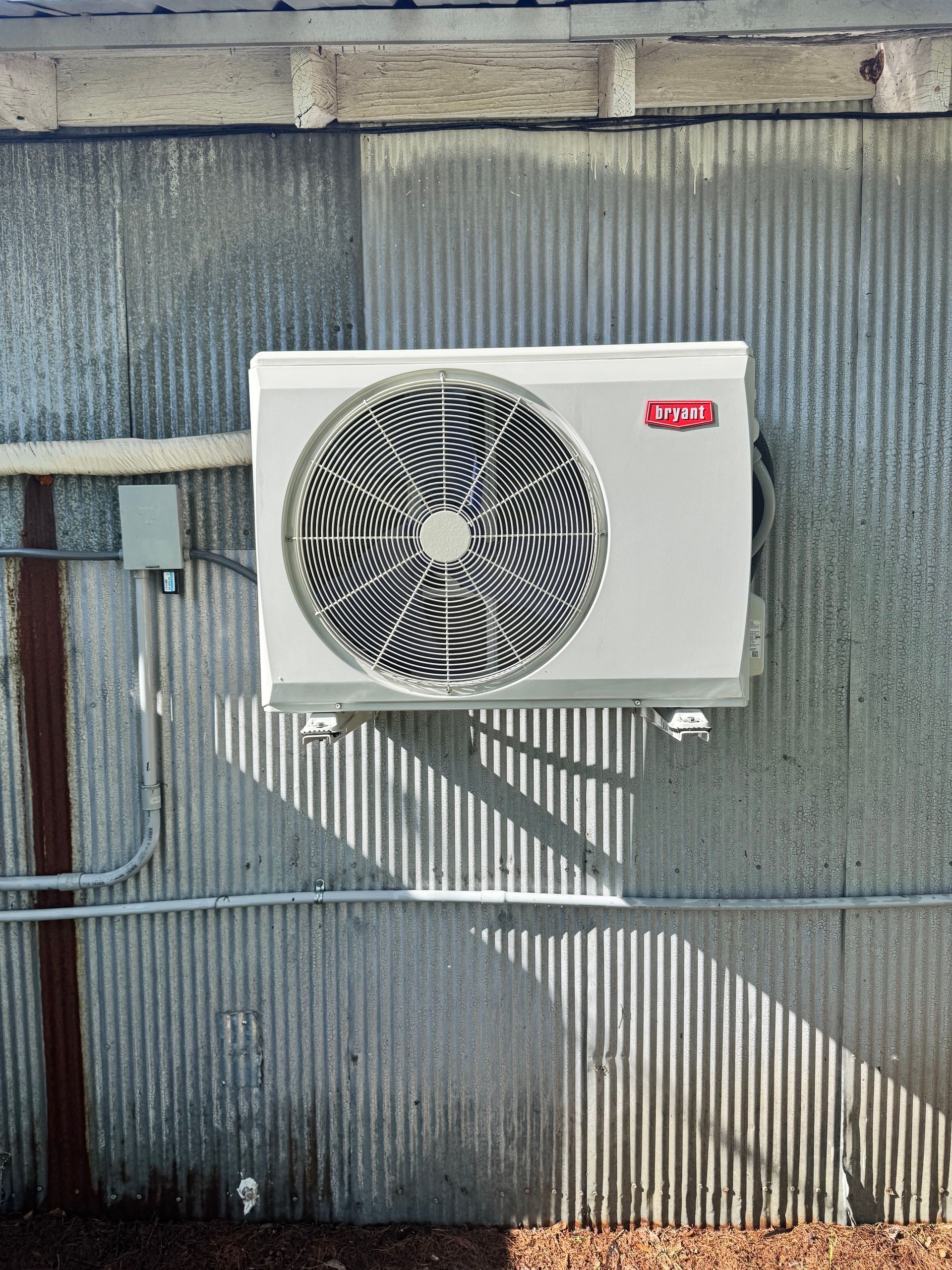 An air conditioner is mounted on the side of a building