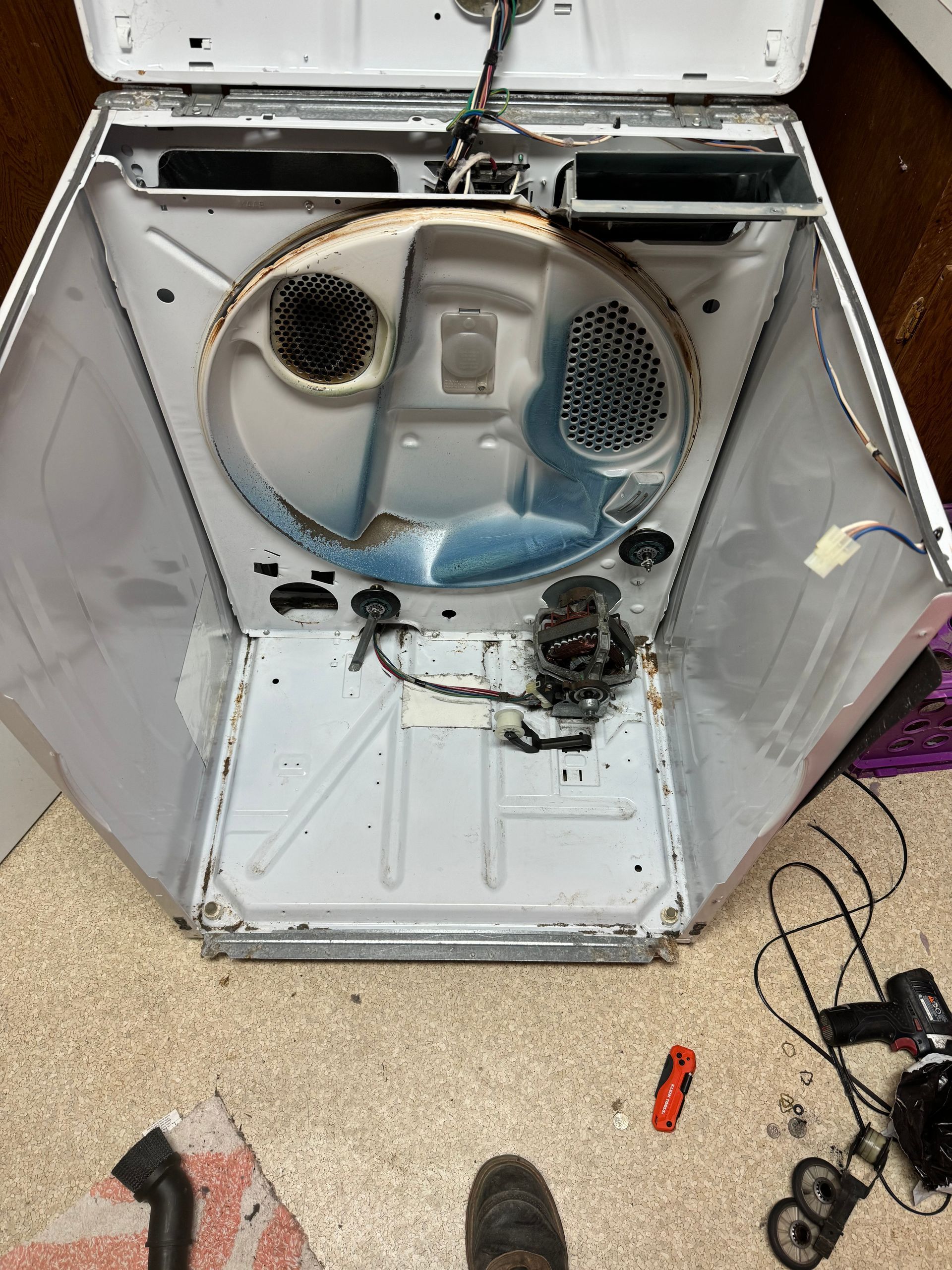 The inside of a washing machine is shown with the door open.