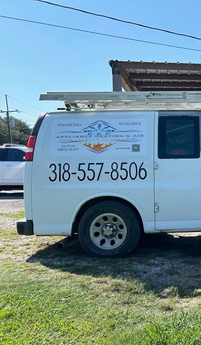A white van is parked in a grassy field.