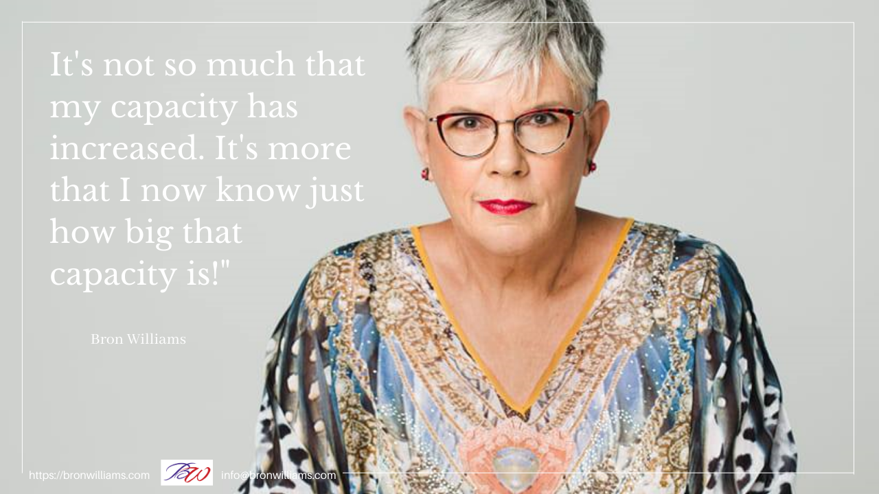 Woman with glasses and colorful shirt, text: 