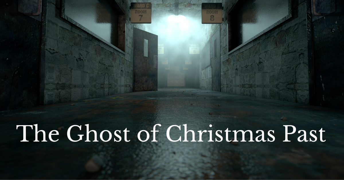 A dimly lit, gray hallway with an open wooden door and boxes labeled 