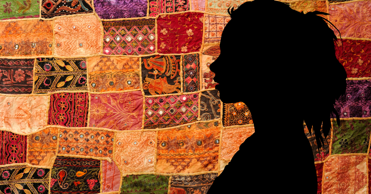 Silhouette of a person against a colorful patchwork fabric backdrop.