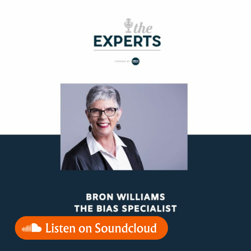Podcast cover: Bron Williams, The Bias Specialist, with smiling face, wearing glasses, in front of a blue background.