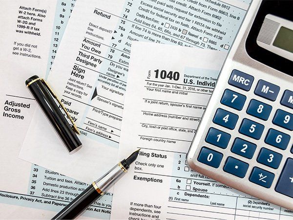 Calculator and 1040 Tax Form | Evansville, IN | Bittner Tax Service, LLC