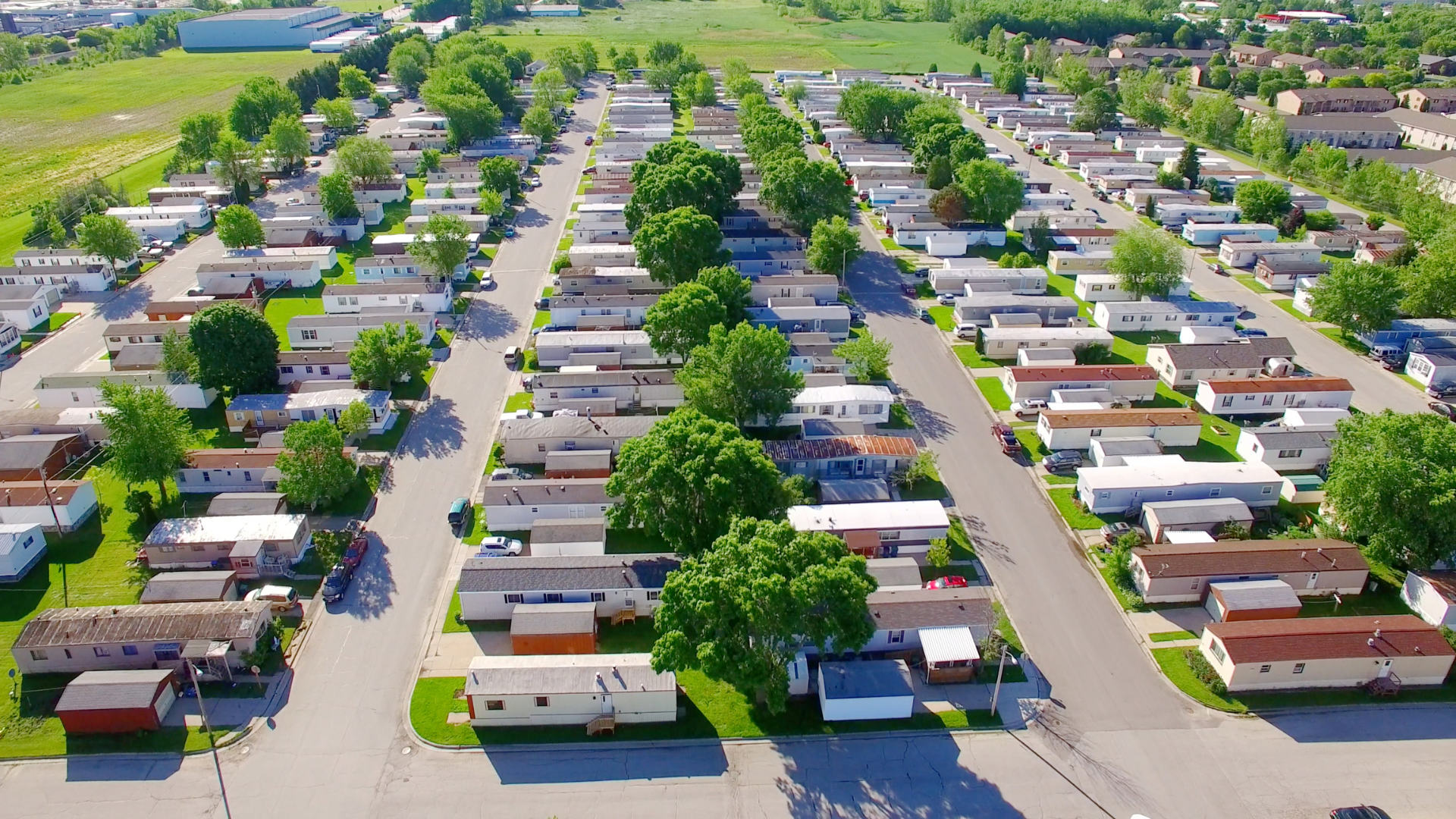 An aerial view of a mobile home park with lots of houses and trees