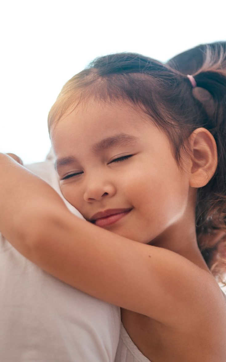 a little girl hugging her stepfather