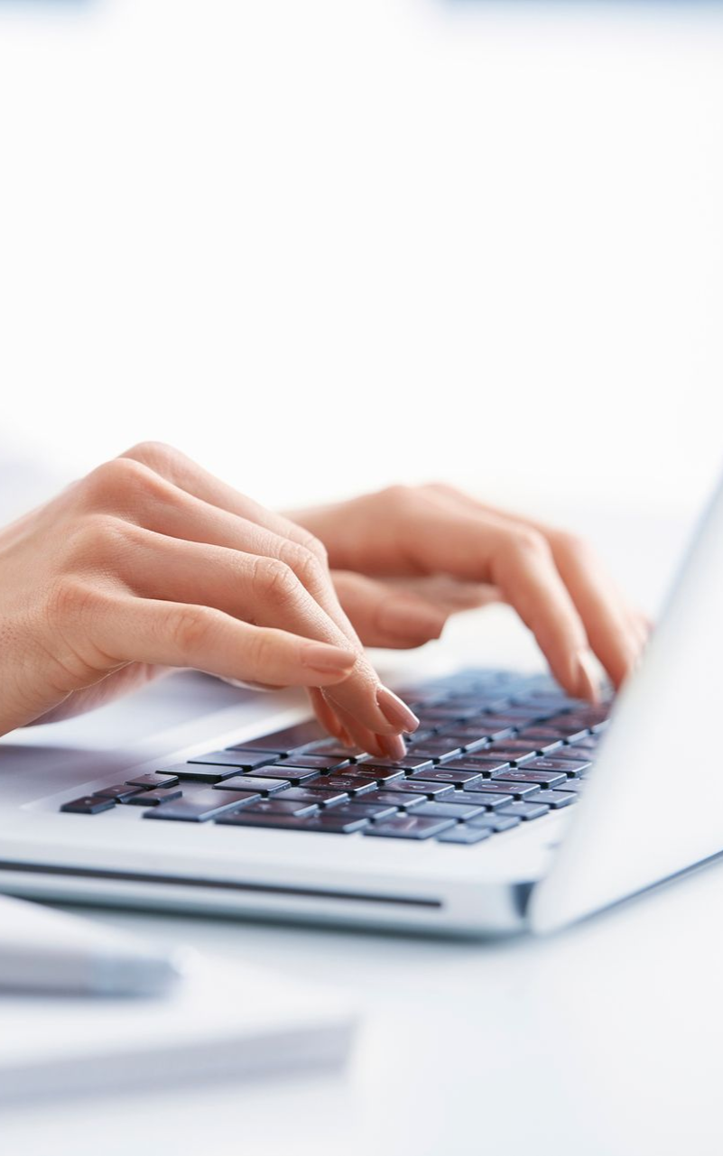 A person is typing on a laptop computer.