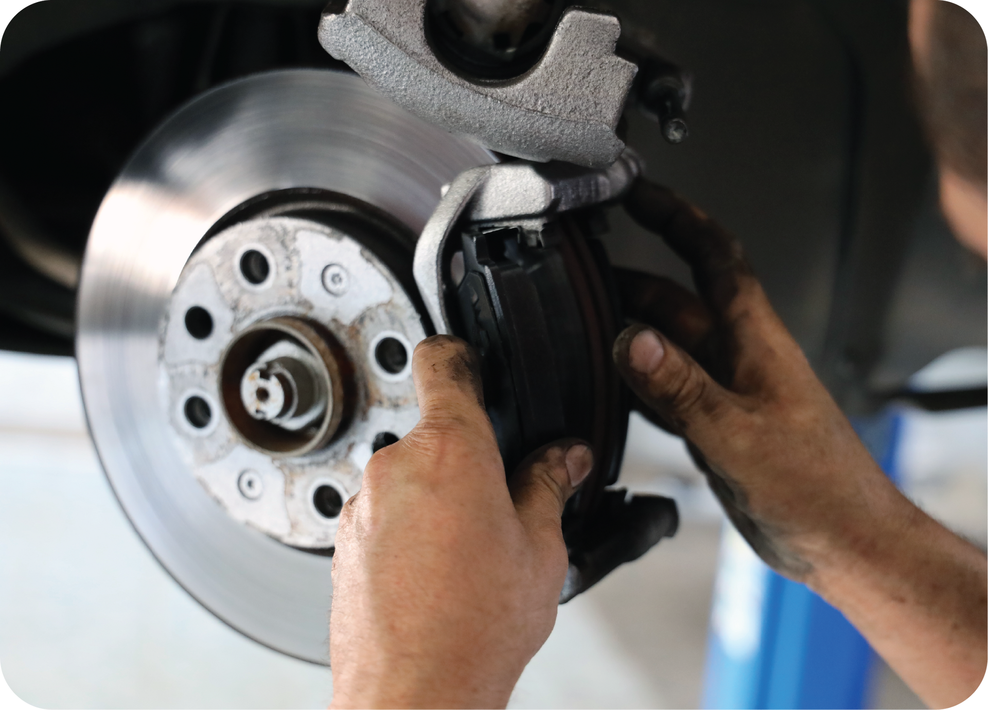 A person is fixing a brake disc on a car.