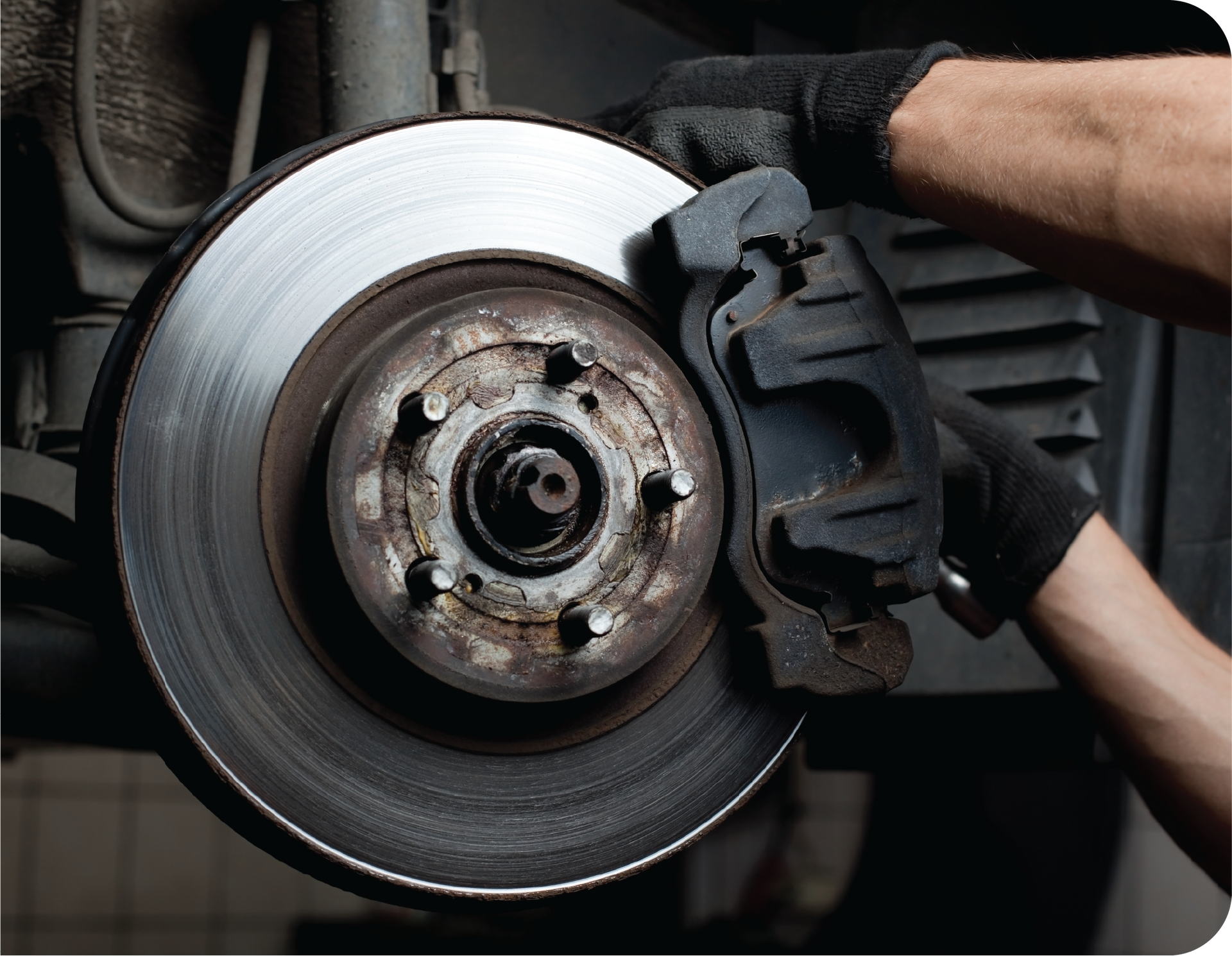 A person is fixing a brake disc on a car.