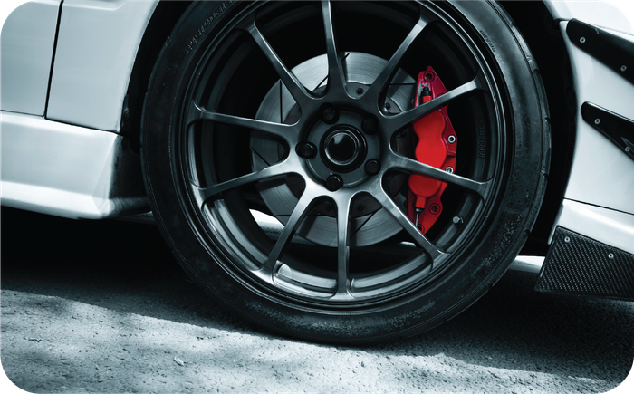 A close up of a car wheel with a red brake caliper