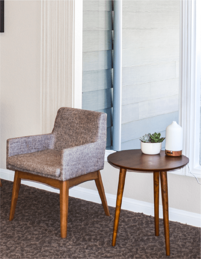 A chair and a small table in a living room