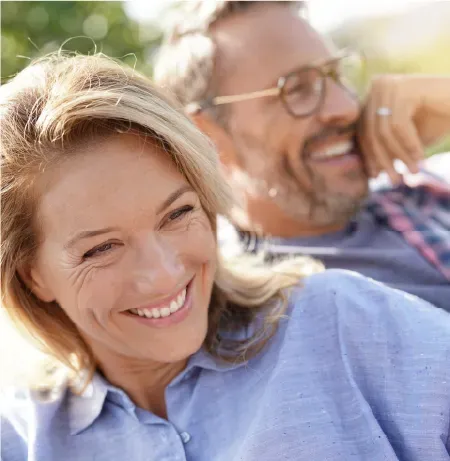 A man and a woman are smiling for the camera