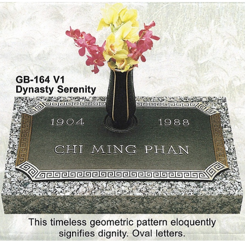 Grave marker: dark plaque with gold trim and inscription 