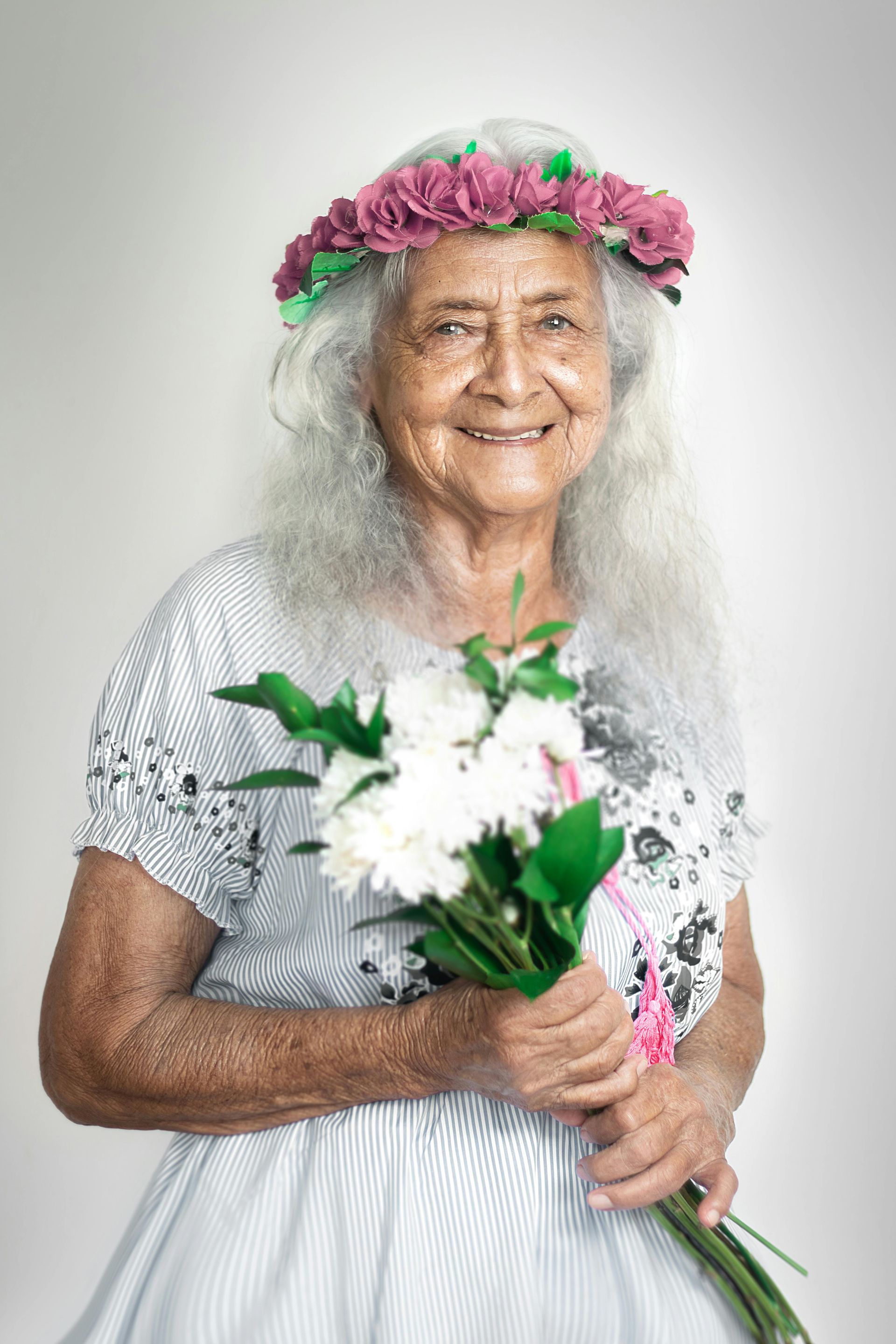 a happy woman holding flowers and smiling