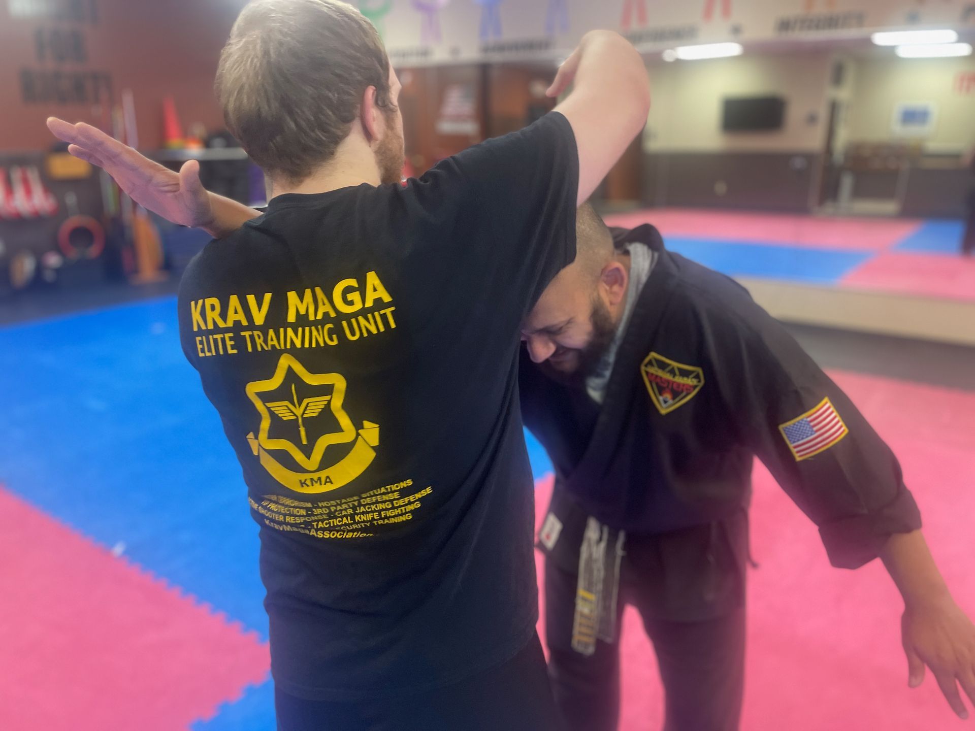 Adult kickboxing students training on heavy bags at Wisconsin National Karate Kickboxing & Krav Maga