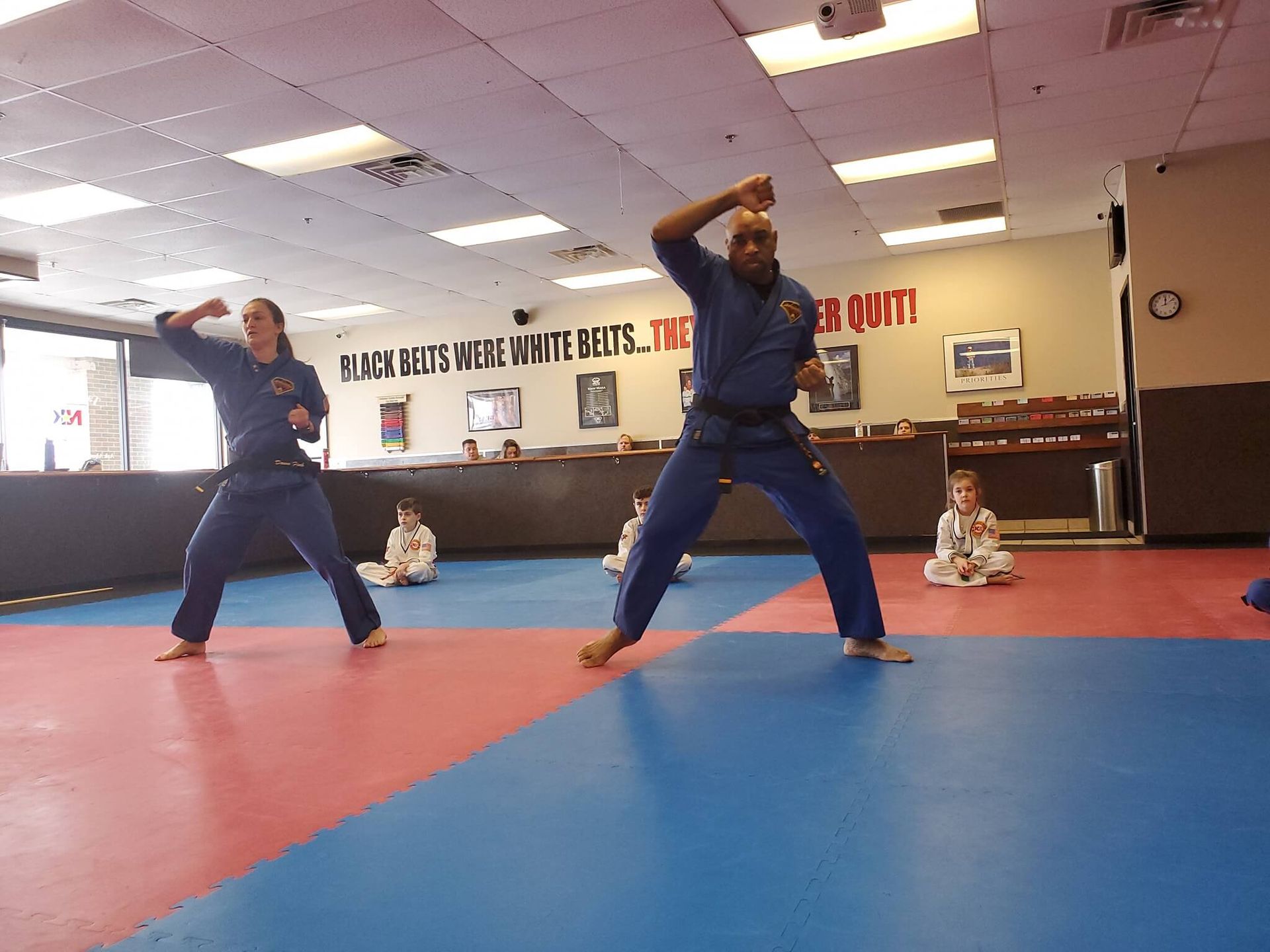 Adults practicing karate drills at Wisconsin National Karate Kickboxing & Krav Maga in New Berlin, WI to build discipline.