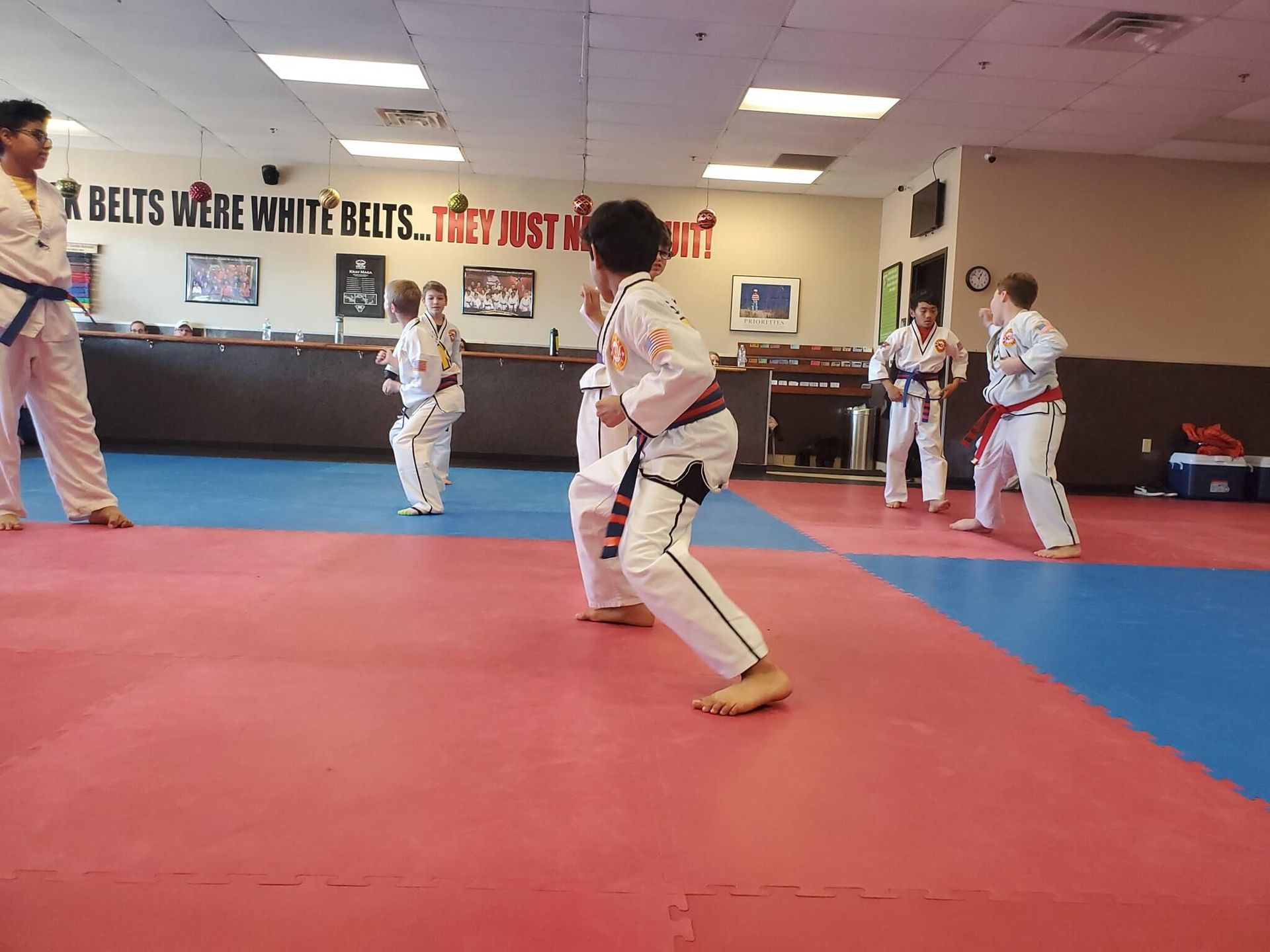 Kids practice karate basics in class at Wisconsin National Karate Kickboxing & Krav Maga in New Berlin, WI, building focus.