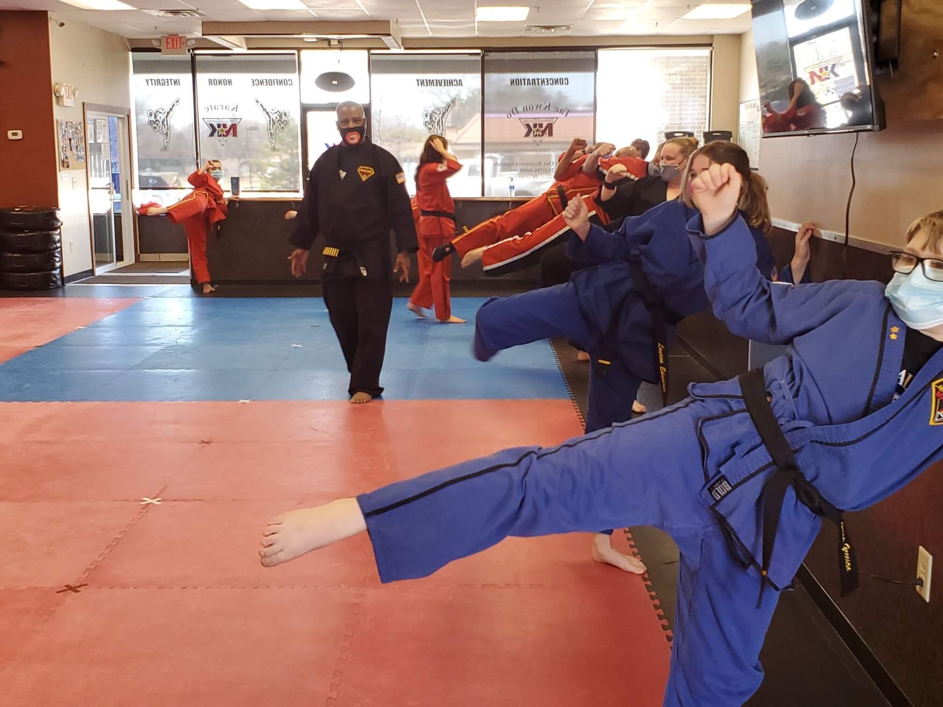 Adults practicing kickboxing combinations at Wisconsin National Karate Kickboxing & Krav Maga.