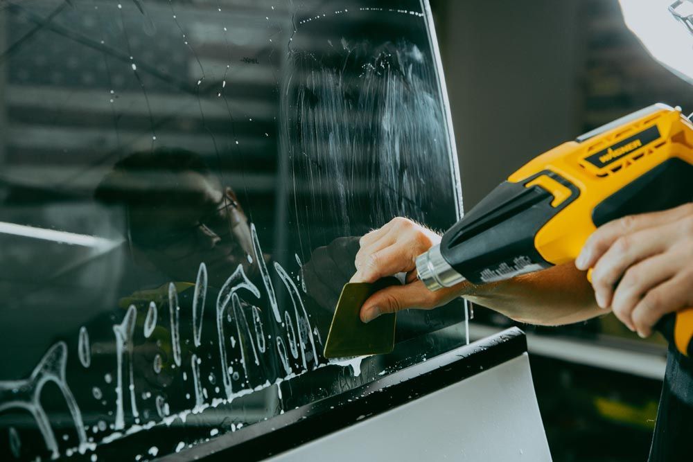 A person is cleaning a window with a sander.