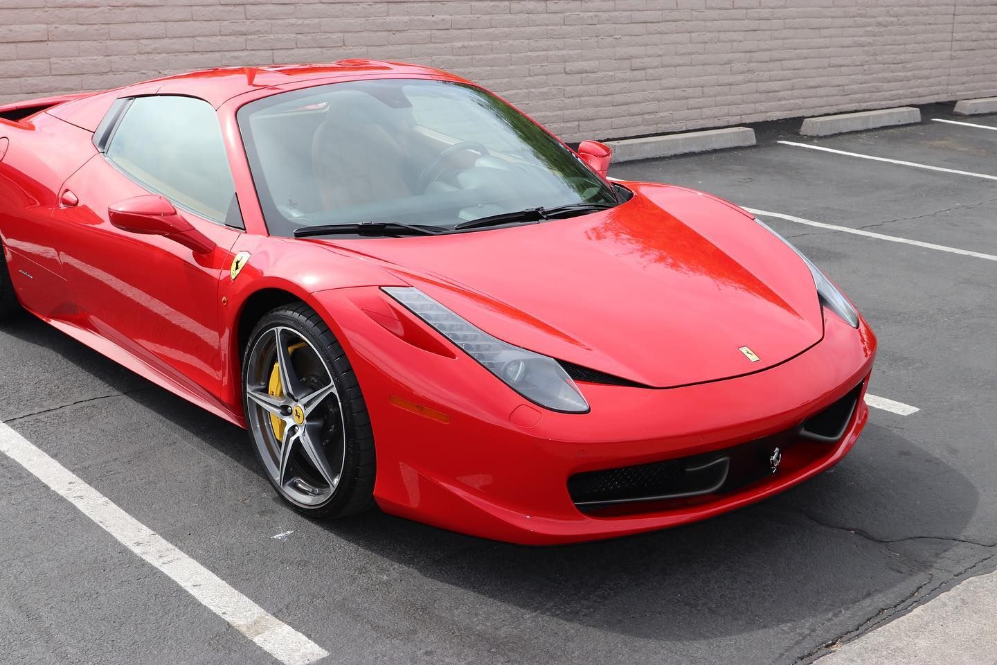 red car parked outside with window tinting