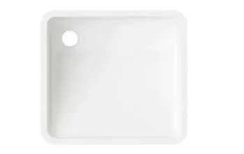 A white square sink with a hole in the middle on a white background.