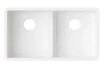 A white kitchen sink with two holes in it on a white background.