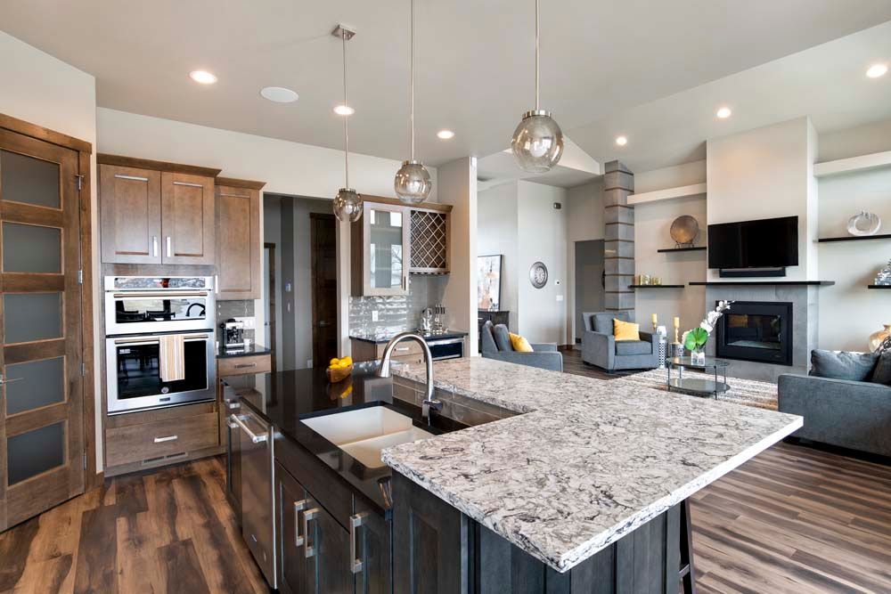 A kitchen with granite counter tops and stainless steel appliances.