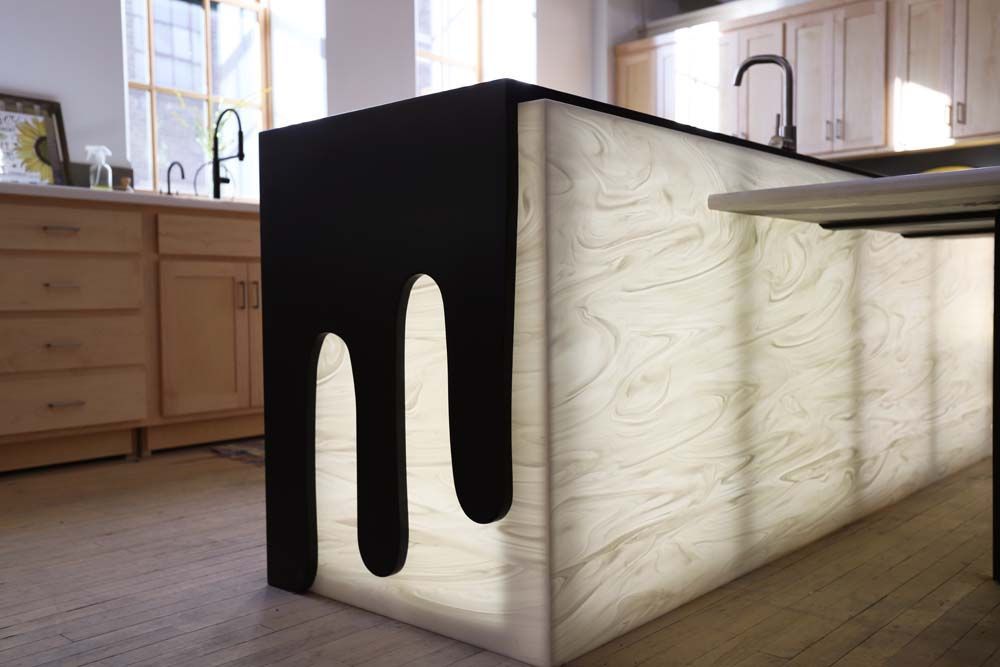 A kitchen with a black counter top and a white counter top