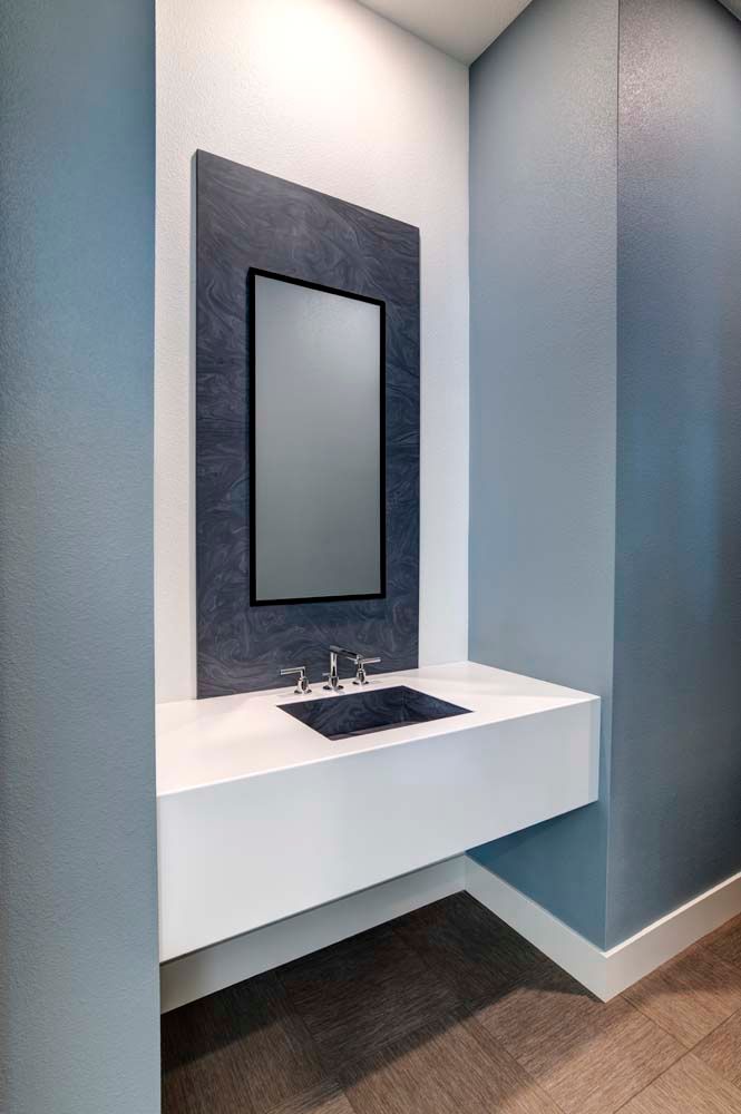 A bathroom with a sink and a mirror on the wall.