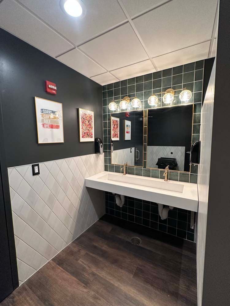 A bathroom with a sink and a large mirror.