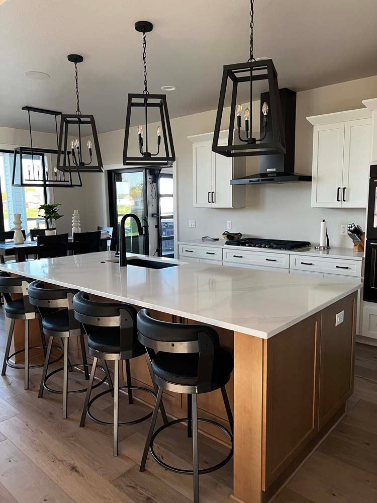 A kitchen with a large island and stools
