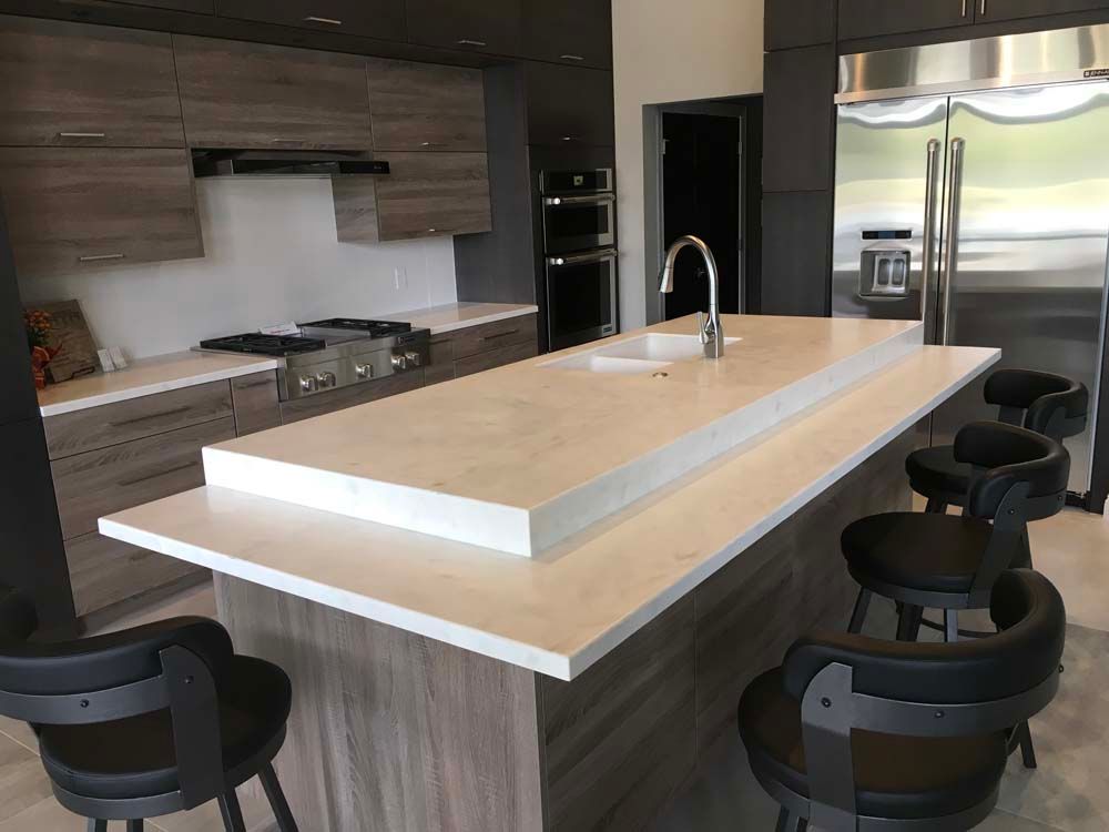 A kitchen with a large island and stools