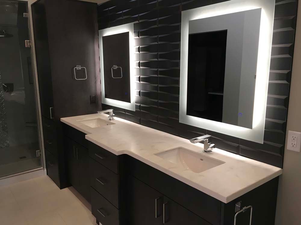 A bathroom with two sinks and two mirrors.