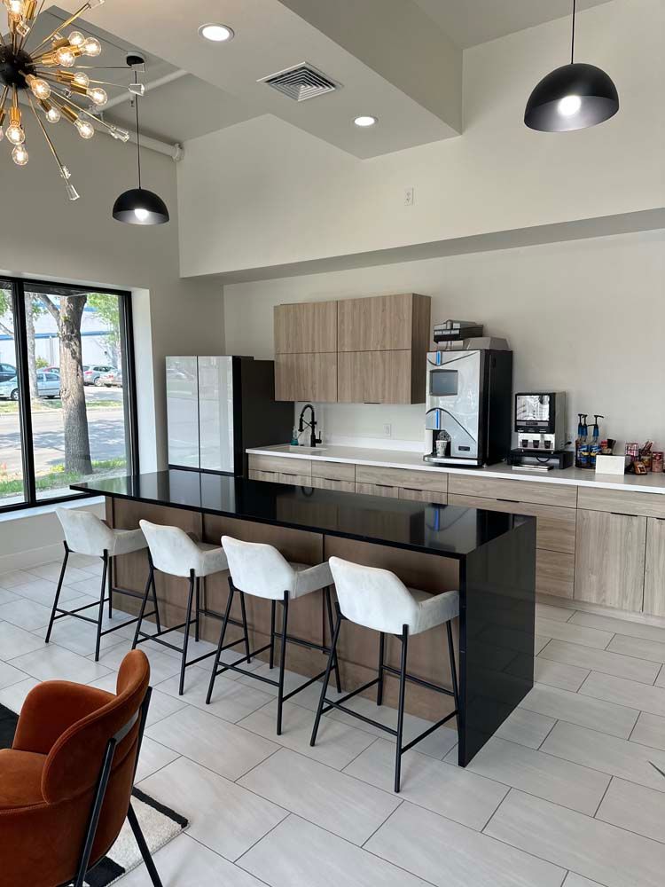 A kitchen with a large island and stools