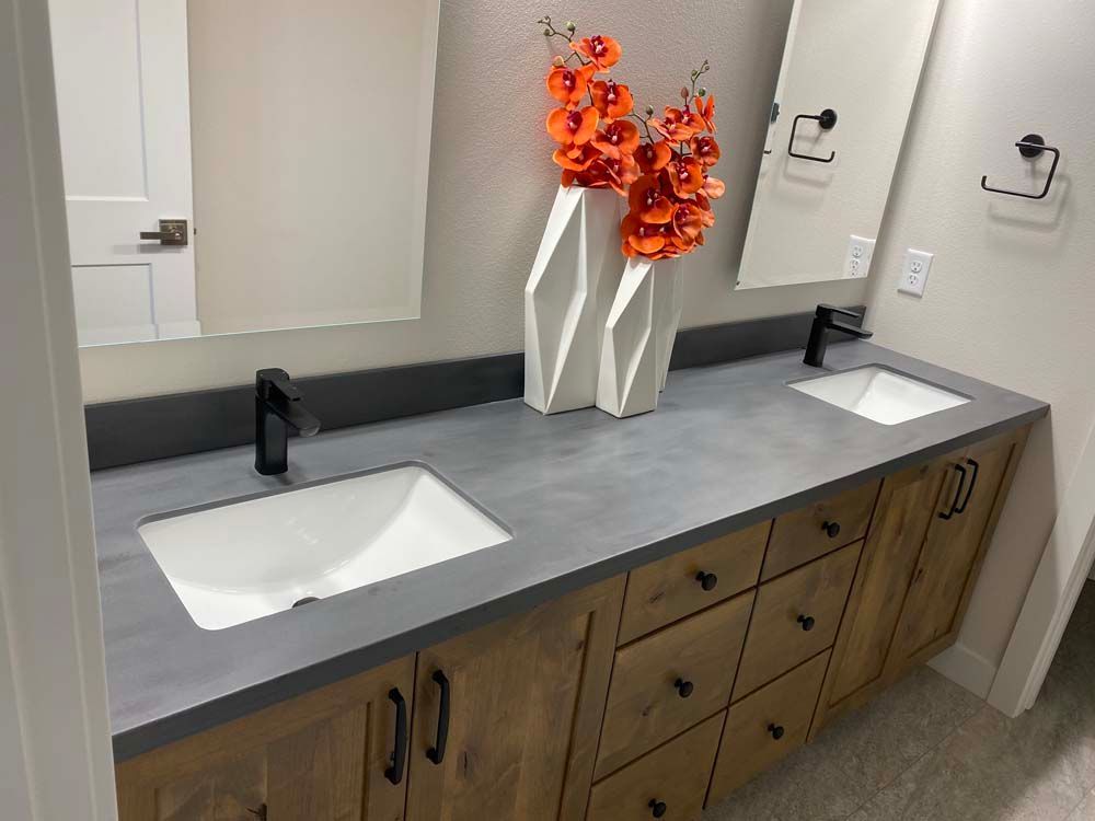 A bathroom with two sinks and two mirrors.