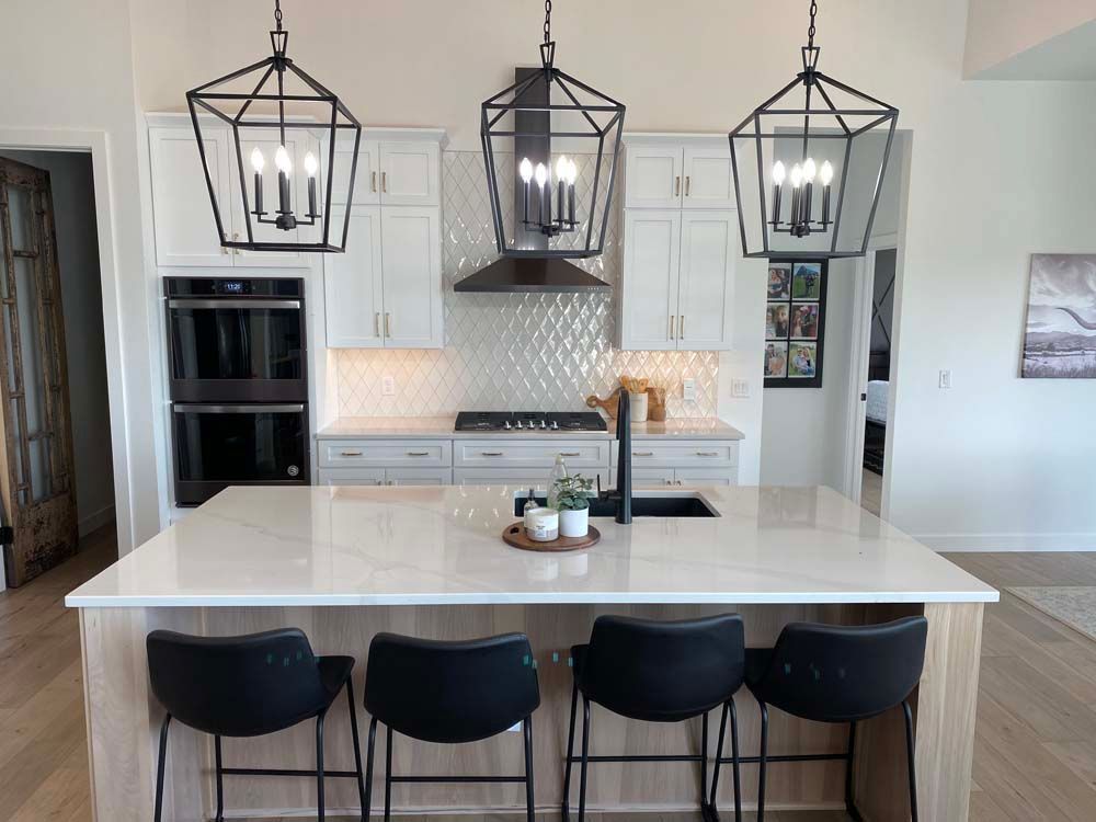 A kitchen with a large island and stools