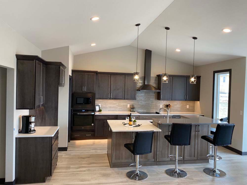 A kitchen with a large island and stools