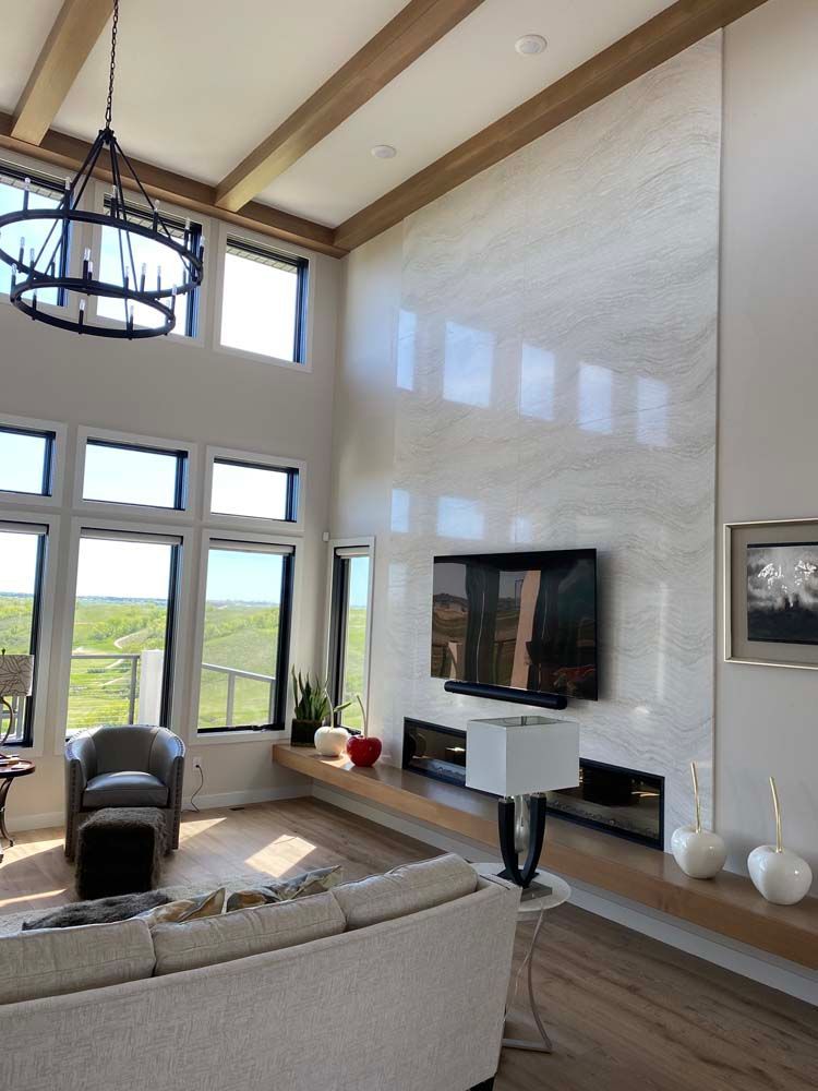A living room with a couch and a television on the wall
