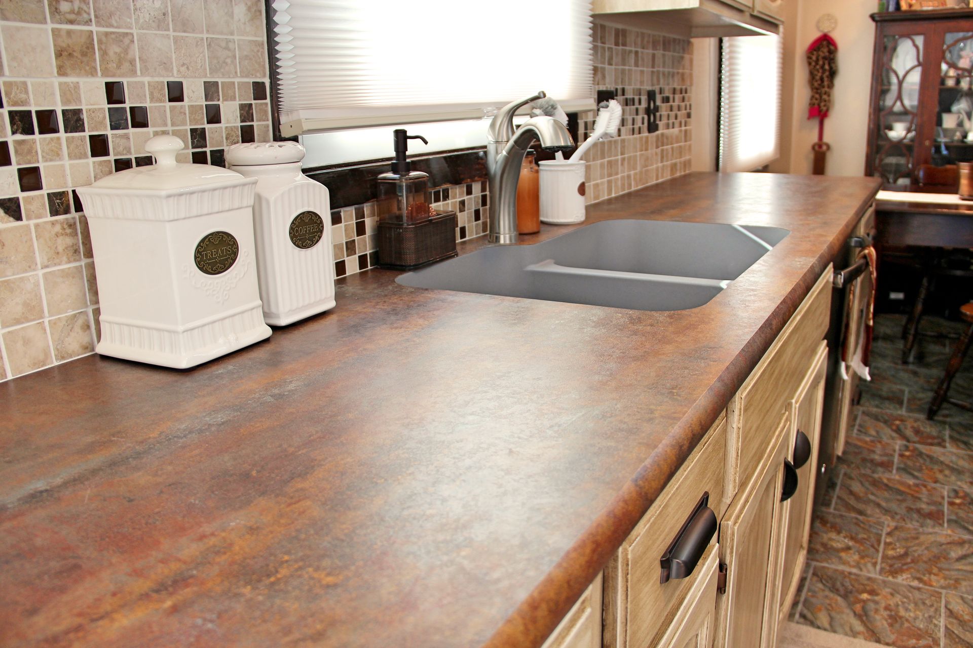 A kitchen with a sink and a counter top