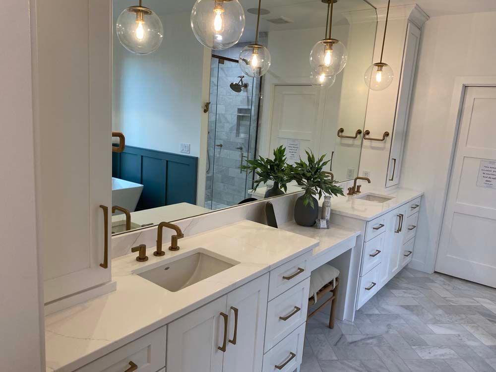 A bathroom with two sinks and a large mirror.