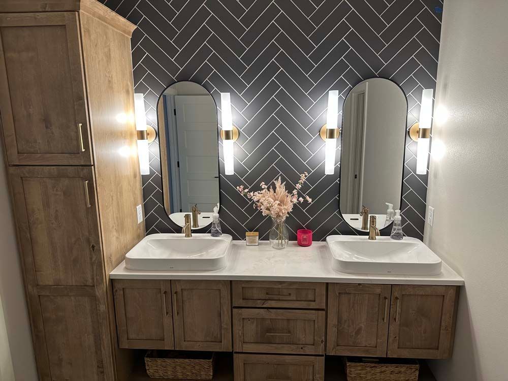 A bathroom with two sinks and two mirrors.